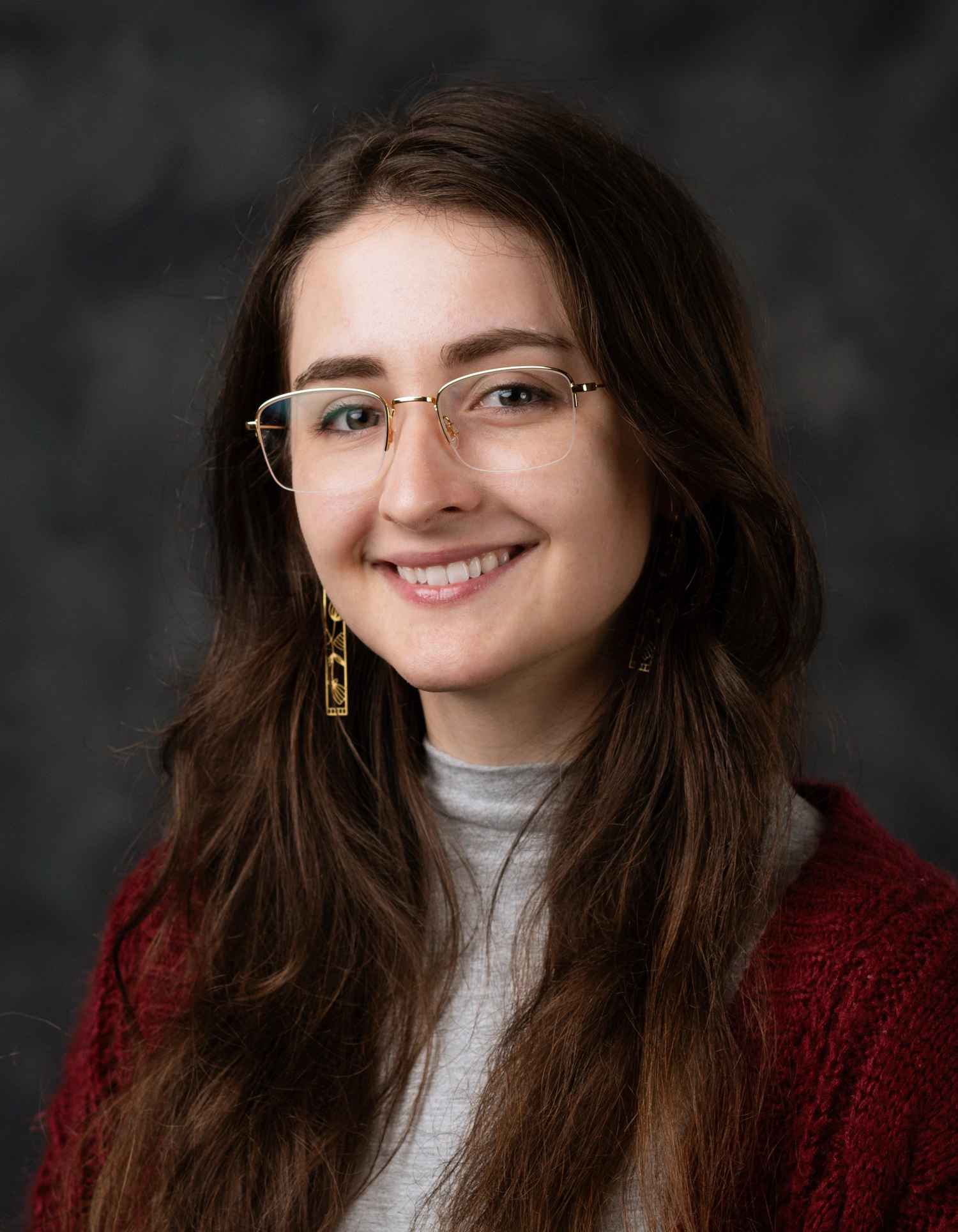 Formal studio headshot portrait of Sarah Kirk